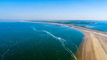 Beach and ocean waves from above taken by a drone in Zeeland in the Netherlands