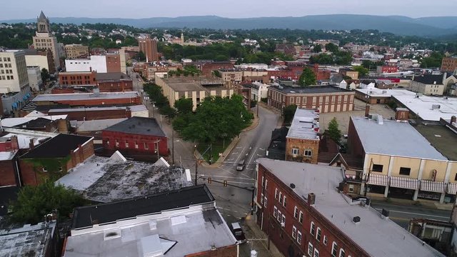 A slow rising aerial establishing shot of the small town of Uniontown, Pennsylvania, about 40 miles outside of Pittsburgh.  	