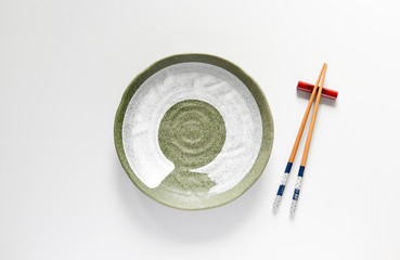 Ceramic plate green and wood Chopsticks oriental style,Copy space,Flat lay