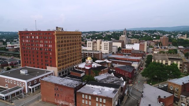 A slow forward moving aerial establishing shot of the small town of Uniontown, Pennsylvania, about 40 miles outside of Pittsburgh.  	