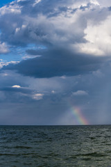 Obraz premium Rainbow under storm sea nature color ecology