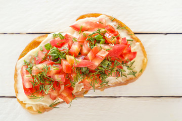 Bruschetta with fresh tomatoes and cheese on white boards. Top view