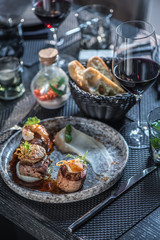 Grilled steak meat with foie gras, shrimp, cheese and glass of red wine