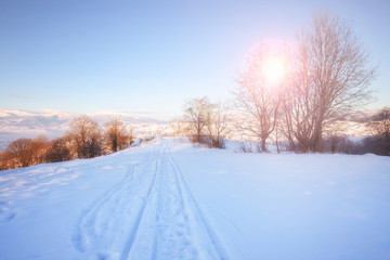 Fototapeta na wymiar Winter mountain landscape. Snowy Alpine mountain hills at sunny day