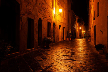 Old European illuminated street at rainy night