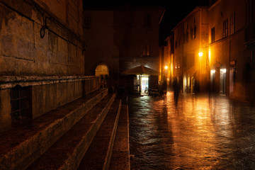 Old European illuminated street at rainy night