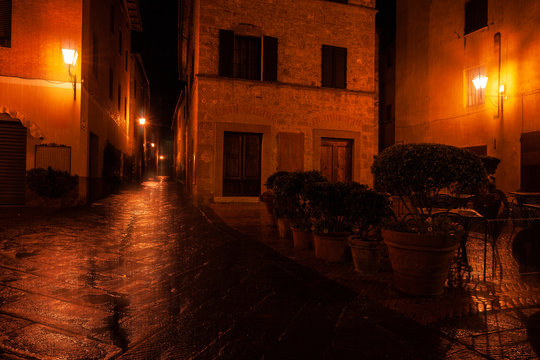 Fototapeta Old European illuminated street at rainy night