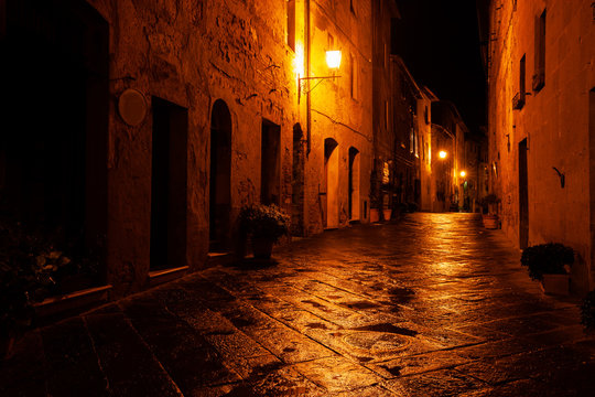 Fototapeta Old European illuminated street at rainy night