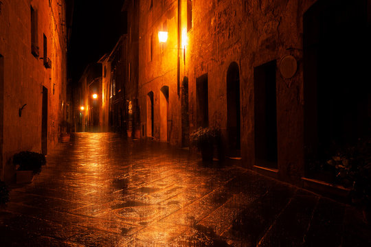 Fototapeta Old European illuminated street at rainy night