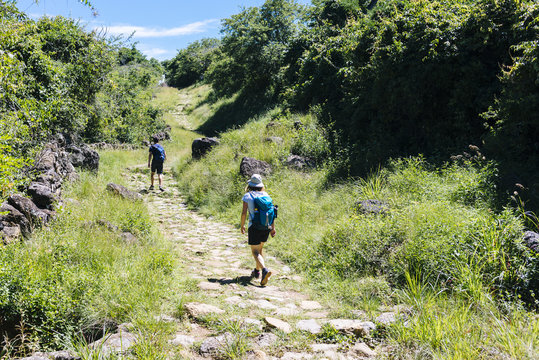 Two hikers on the ancient stone paved road from Barichara to Guane called "El Camino Real". , Barichara/ Colombia/ South America