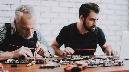 Two Men Repairing Hardware Equipment from PC.
