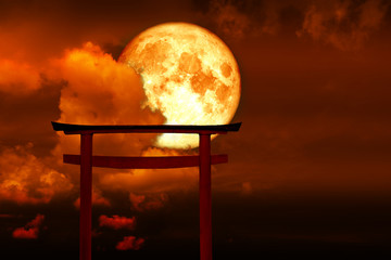 super blood moon silhouette torii wooden Japanese pillar stand on sea night sky