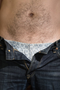 Close up shot of man in jeans with open zipper