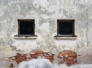 Fragment of vintage brick wall with windows. Textural background.