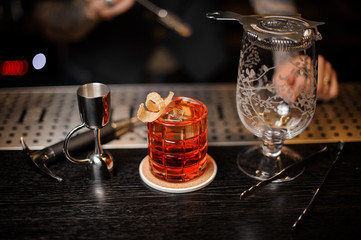 Barman making a fresh and sweet summer cocktail using bar equipment