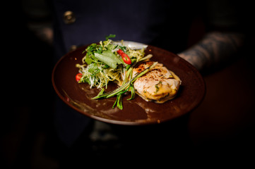 Tasty and hot chicken fillet with fresh vegetable salad