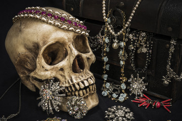 Still life with a human skull with old treasure chest and gold, diamond