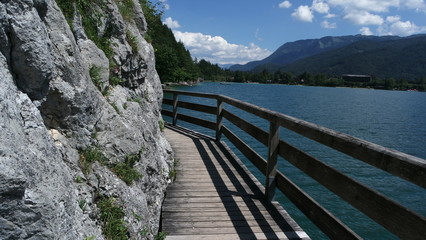 Wooden natural trail good for walking and jogging and a view of the beautiful lake Wolfgangsee in Austria.