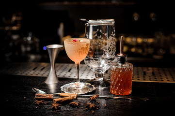 Elegant cocktail glass filled with tasty and sweet summer drink decorated with flower and powder
