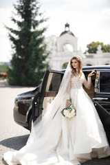 Gorgeous bride steps out of a rich black car