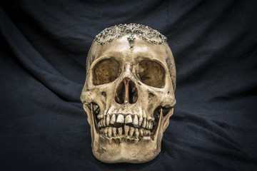 Still life with a human skull with the old, in with the diamond and jewelry