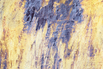 Scratched yellow and violet paint on metal texture