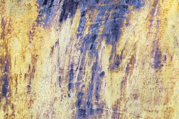 Shabby yellow and violet paint on metal texture
