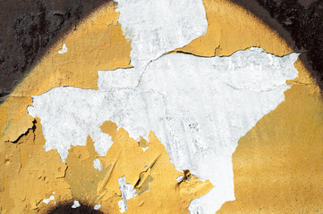 Spots of cracked yellow and brown paint