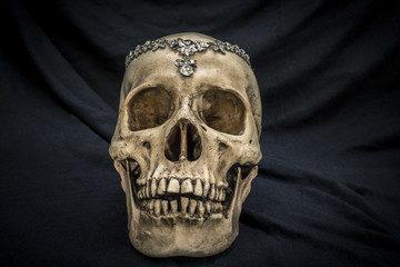 Still life with a human skull with the old, in with the diamond and jewelry