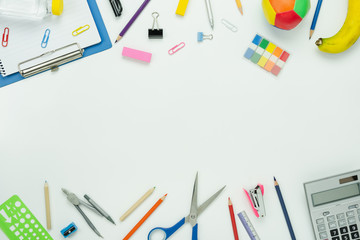 Table top view aerial image of back to school of education season background concept.Flat lay paper of variety stationary with note nook and essential objects on modern white wooden.space for mock up.