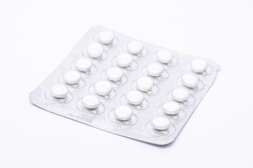 Medicine pills in silver tinfoil lining