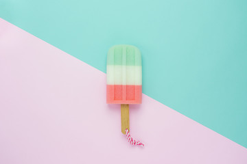 Table top view aerial image of food dessert of summer season background concept.Flat lay minimal object beautiful of colorful ice cream on modern rustic pastel paper of green & pink wallpaper.