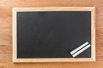 rectangle blank slate chalk board with wooden frame on wooden table