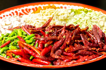 Fresh red and green and dried chilli ingredients of Thai red curry paste recipe.