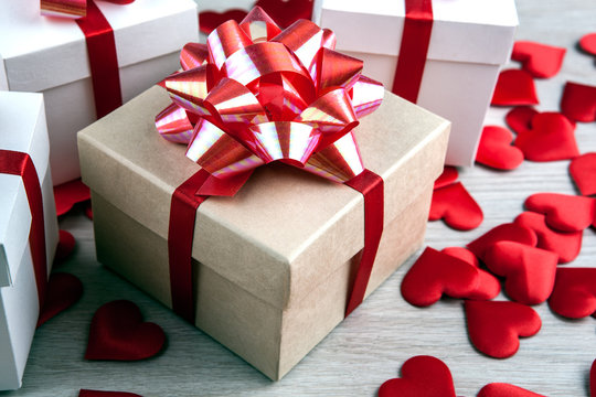 gift box on a gray background and textile heart shapes
