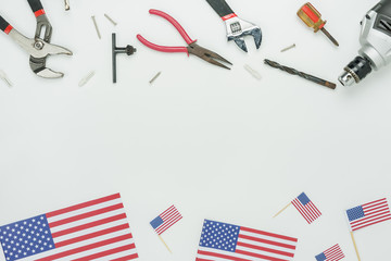 Fototapeta na wymiar Table top view aerial image of decoration the sign of USA labor day on Sep 3,2018 background concept. Flat lay accessories US flag and essential tools worker on modern white wooden with copy space.