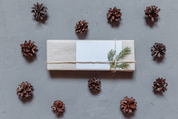 Christmas background with fir tree and decor, gift boxes. Top view with copy space, gray plastered background