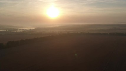 Dawn in the field. Fog over the field.