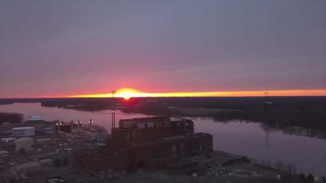 Majestic HD drone video of industry and nature together- a power plant on the river with a gorgeous sunset