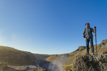 A traveler enjoy the view of Gullfoss waterfall , Iceland