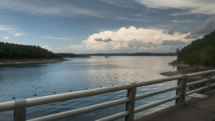 Fototapeta na wymiar Beautiful lake view of storm clouds and mountains, drive over dam