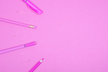 Top view of school or office supplies of a pastel pink color on a pastel pink background, copy space on the right (minimal concept)