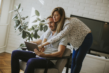 Couple using digital tablet together