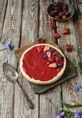 yummy red strawberry pie on wooden table