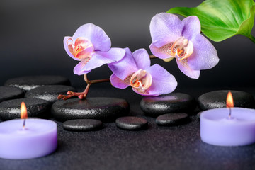 Obraz na płótnie Canvas spa concept of zen stones, lilac orchid, candles
