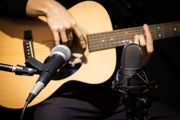 Obraz na płótnie Canvas microphone recording acoustic guitar sound