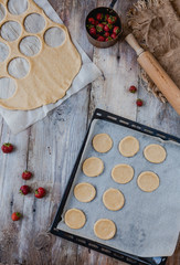 top view of dough and strawberries for cookies on table