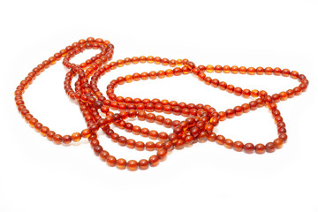 Amber. Beautiful bright beads of petrified resin on a white background. Amber texture and background. Jewelry product of natural and fashionable amber mineral.  Sun stone. Crystal. Bokeh effect