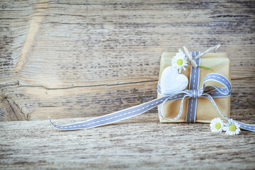 Gift box on rustic wooden background 