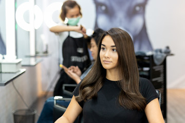 Fototapeta na wymiar Portrait of beautiful mixed race young girl with long smooth hair in salon.